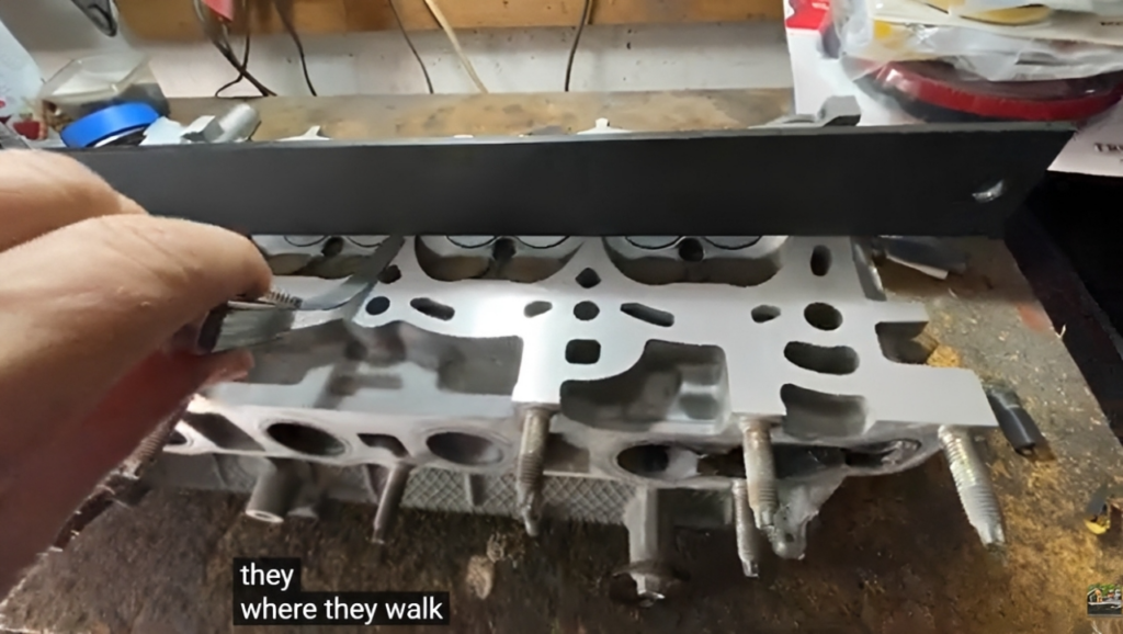 Checking Cummins 6BT cylinder head surface warpage with straight edge and feeler gauge