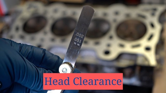 Checking Cummins 6CT cylinder head surface warpage with straight edge and feeler gauge